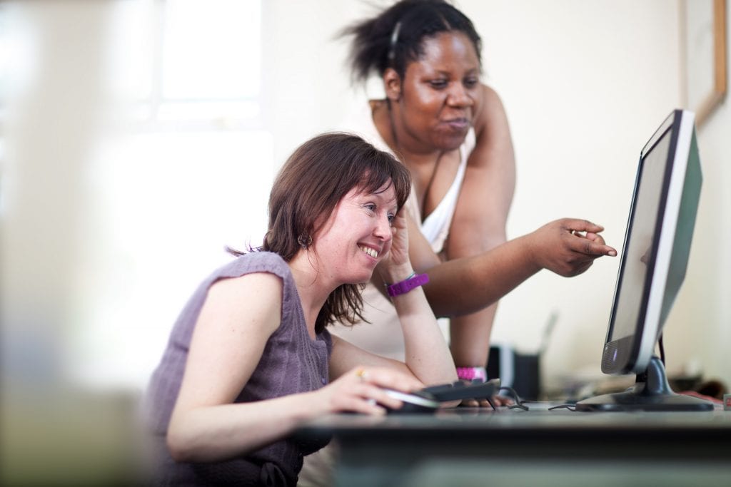 people looking at a computer