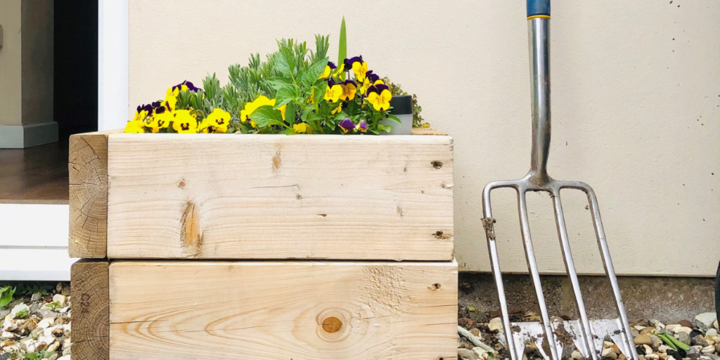 picture of flower box and gardening tools