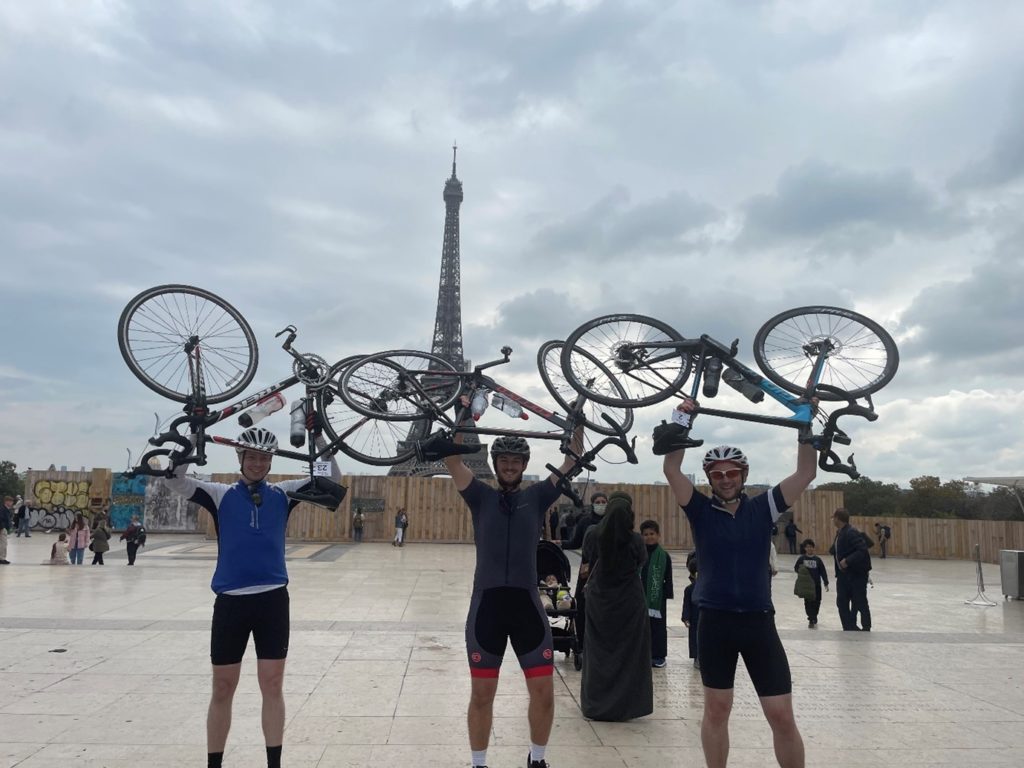 Finders Keepers team holding up bikes in front of Eiffel Tower